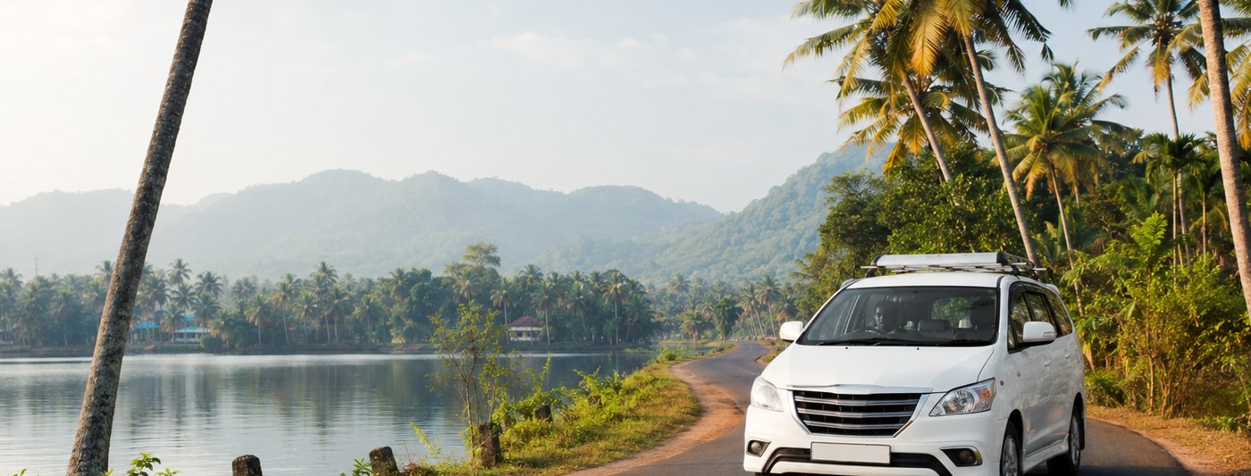Kerala taxi on a palm-lined backwater road heading inland from Kochi